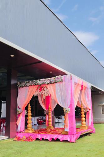 a marquee with a pink and yellow tent at Hotel Laxmi Elite Karad in Karad