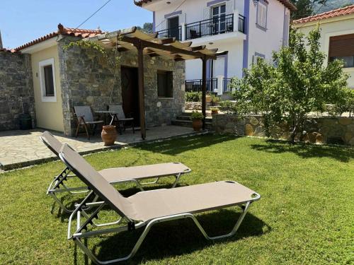 a lounge chair in a yard in front of a house at Christina in Ágios Konstantínos