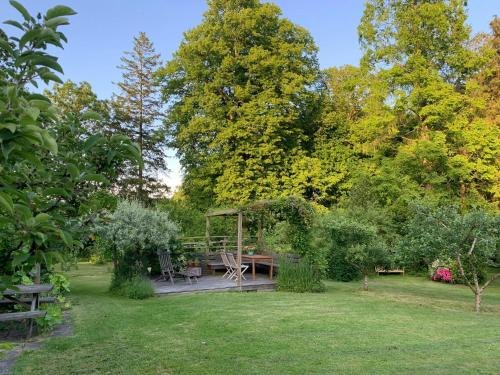 a picnic table in a garden with trees at Historic Gamekeepers House At Tranekær Castle in Tranekær