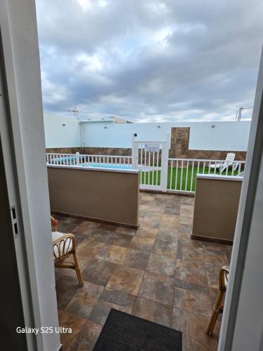a balcony with tables and chairs on a building at apartamento 1 tenerife sur in Arona