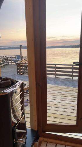 a door to a deck with a view of the water at En Perle ved Masfjorden in Masfjorden