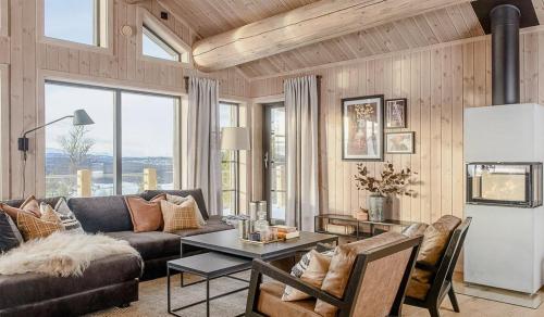 a living room with a couch and a table at Modern Cabin With Beautiful Design By Gålåvatn in Gålå