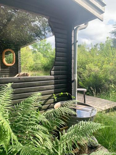 a small house with a boat sitting on a deck at Cozy Summer House In Rørvig With Historical Charm in Rørvig