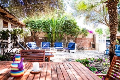 a patio with chairs and a wooden table and chairs at Casa Josto a due passi da Spiaggia Maladroxia in Maladroxia