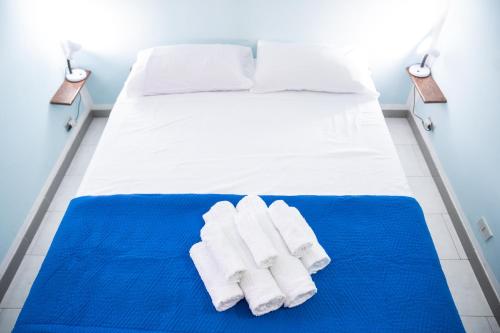 a bedroom with a bed with towels on it at Casa Josto a due passi da Spiaggia Maladroxia in Maladroxia