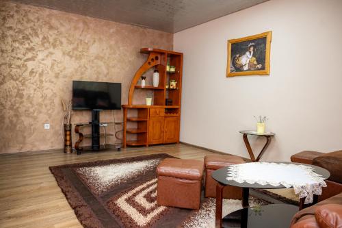 a living room with a couch and a television at Complex Koko Hills in Sapareva Banya