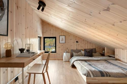a bedroom with a bed and a desk at Cabin Overlooking Ryfylke Fjord in Høyvik