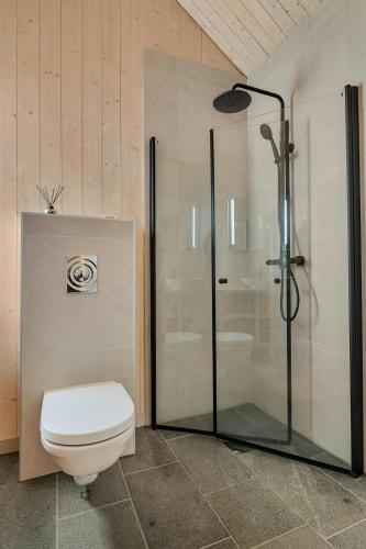 a bathroom with a toilet and a glass shower at Modern Cabin In Harmony With Nature in Moen i Målselv