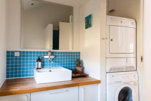 a kitchen with a sink and a washing machine at West Jutland In Peaceful Havblik Setting in Nørlev