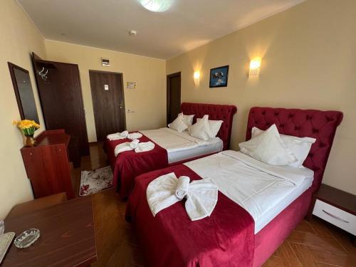 a hotel room with two beds with bows on them at Hotel Vera in Eforie Nord