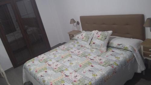 a bedroom with a bed with a comforter and pillows at Hostal Boutique Bajamar in Nerja