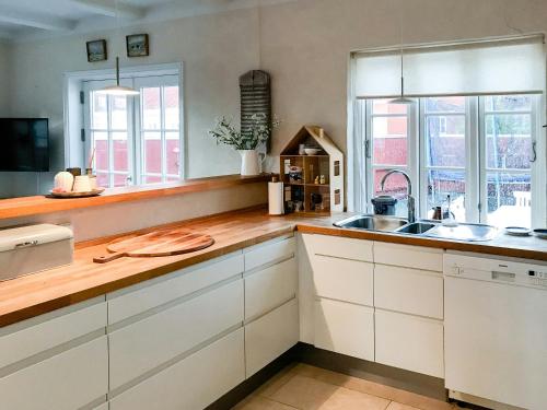 a kitchen with white cabinets and a sink at Live In Classic Skagen House In Skagen's Heart in Skagen