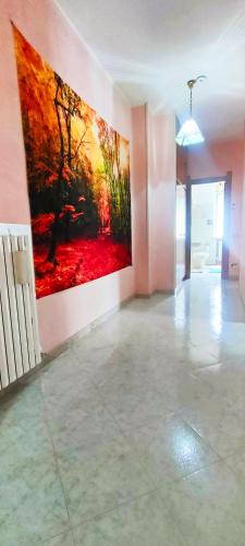 a living room with a large painting on the wall at Camera a Catanzaro in villa relax ""oasi verde"" in Catanzaro