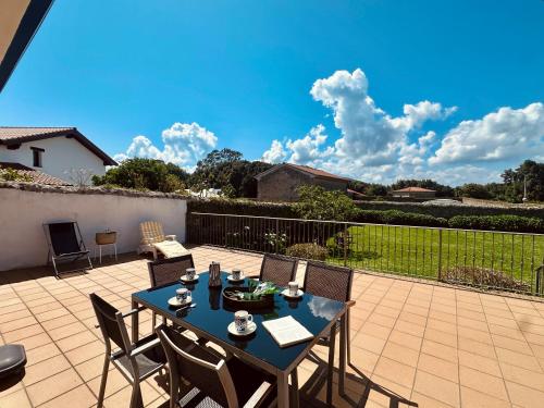 a patio with a table and chairs on a patio at La Casita Azul - 1004 in Arnuero