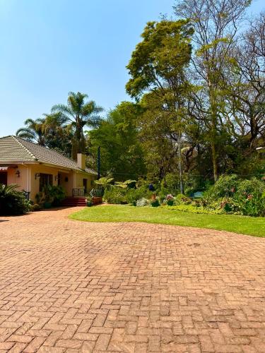 a brick driveway in front of a house at A boutique lodge situated in a serene environment - 2026 in Harare