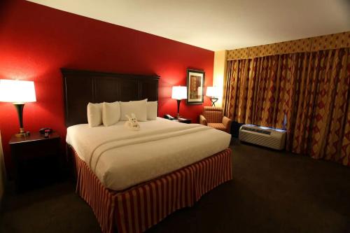 a hotel room with a large bed and red walls at Hotel DSR Tark Plaza Near IGI Airport Delhi in New Delhi
