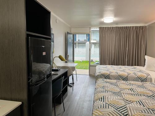 a hotel room with two beds and a sink at Studio 6 Bay Minette AL in Bay Minette