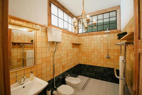 a bathroom with a toilet and a sink at Rustic Holiday Apartment, Lovingly Restored in Rambin