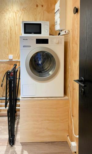 a washer and dryer sitting in a kitchen at Modern Wooden House Near Halkær Bredning in Nibe