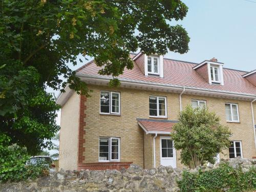 a house with a stone wall in front of it at Woodland View in Shanklin