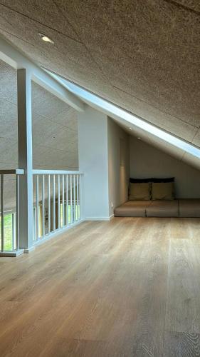 a empty room with a couch in the middle of a room at Modern Holiday Home Near Vesterløkken Beach in Tanderup