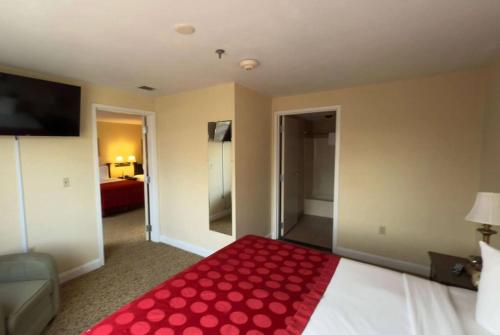 a hotel room with a bed with a red blanket at Hotel Royal Le Mount Near IGI Airport Delhi in New Delhi