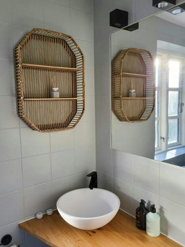 a bathroom with a large white sink and two mirrors at Country House With Large Garden On Langeland in Humble