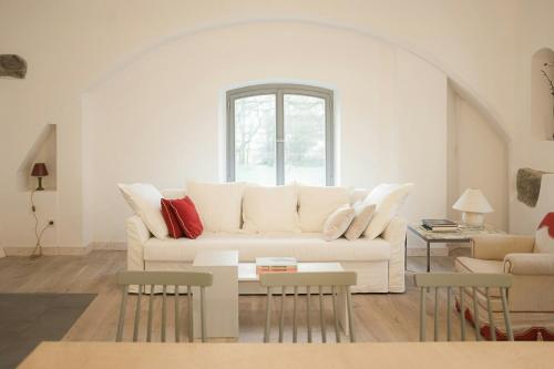 a living room with a white couch and a window at Holiday Apartment In Manor House On Rügen in Poseritz