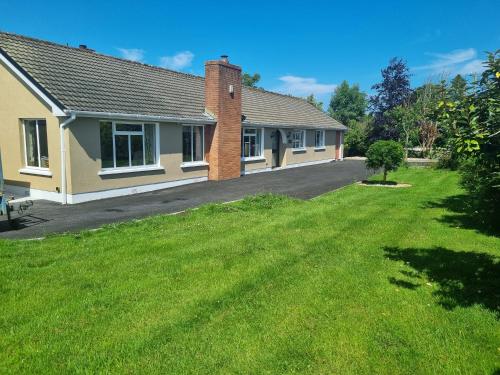 a house with a green lawn in front of it at Rosemount in Sligo