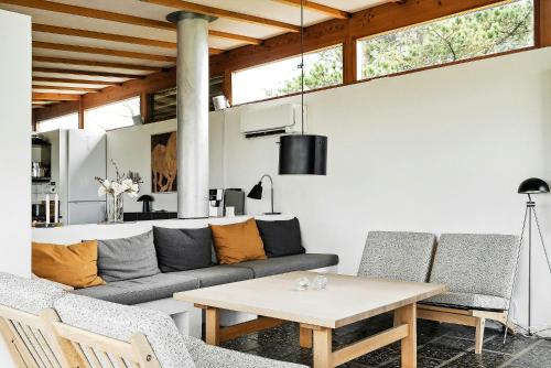 a living room with a couch and a table at Family Time At Sea Air Nature By Ebeltoft Bay in Ebeltoft