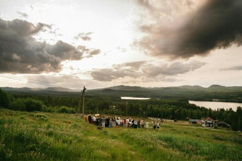 a group of people standing on a hill in a field at Active Holiday In Dalarnas Gopshus in Blyberg