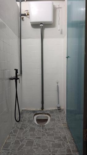 a bathroom with a toilet in the floor of a shower at Familia 69 Homestay in Sungai Petani