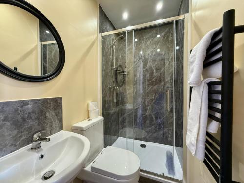 a bathroom with a toilet sink and a shower at The Crescent York in York