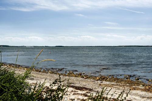 a beach with a large body of water at Home By Beach With Panoramic Views in Nykøbing Sjælland