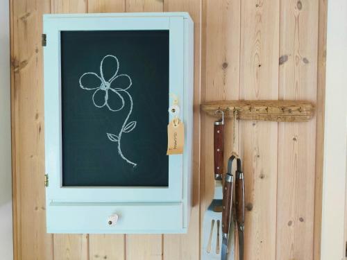 a chalkboard with a drawing of a flower on it at Home Near Beach With Wilderness Bath in Sindrup