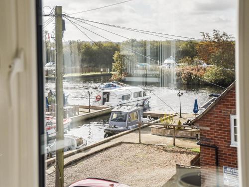 a view of a marina with boats in the water at River View in Horning