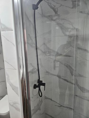 a shower with a glass door next to a toilet at apt granalacante in Gran Alacant