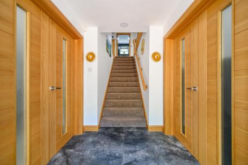 a hallway with wooden doors and stairs in a house at -RD7B- For your relaxed and Cosy stay with Free WiFi in Batley