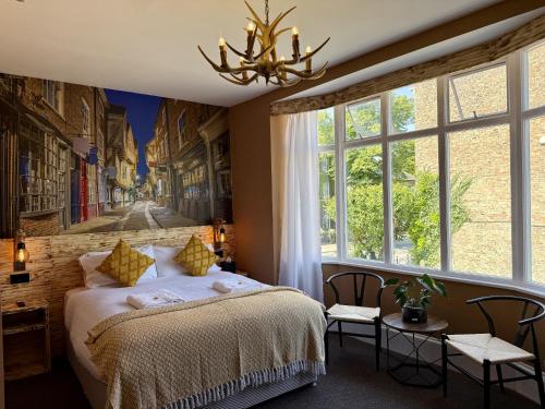 a bedroom with a bed and a large window at The Crescent York in York