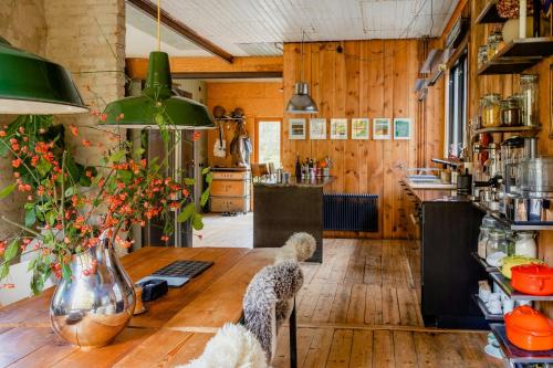 a kitchen with wooden walls and a wooden table at Restored Quarry House Near Nobel Laureate Home in Lönsboda