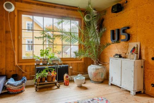 a room with a us sign on the wall and plants at Restored Quarry House Near Nobel Laureate Home in Lönsboda