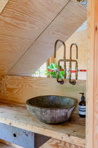a bathroom with a stone sink on a wooden counter at Restored Quarry House Near Nobel Laureate Home in Lönsboda
