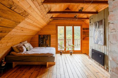 a bedroom with a bed in a wooden house at Restored Quarry House Near Nobel Laureate Home in Lönsboda