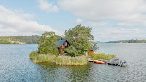 a house on an island in the middle of a lake at Cabin On Private Island In Stockholms Archipelago in Mörkö
