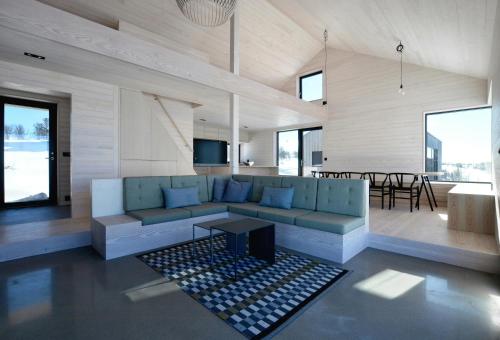 a living room with a blue couch and a table at Cabin Overlooking Hallingskarvet National Park in Geilo