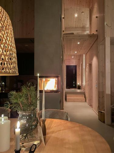 a dining room with a table with a candle on it at Cozy Cabin At The Gateway To Jotunheimen in Vaga