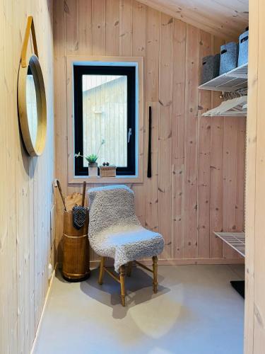 a room with a chair and a window at Cozy Cabin At The Gateway To Jotunheimen in Vaga
