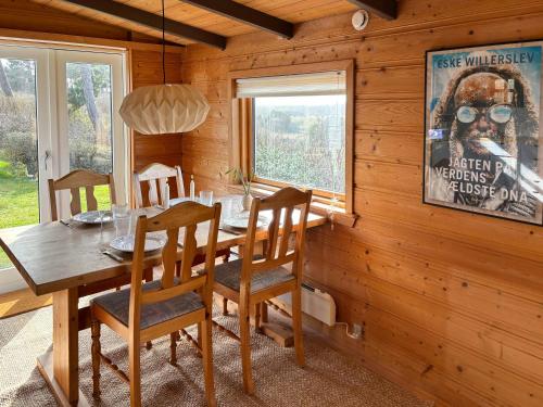 a dining room with a wooden table and chairs at Cozy Holiday Home With Sea Views in Nykøbing Sjælland