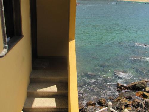 a stairway looking out at the ocean from a building at Casa Papaya in Yelapa
