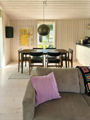 a living room with a couch and a table at Family-Friendly Home Near Child-Friendly Beach in Nykøbing Sjælland